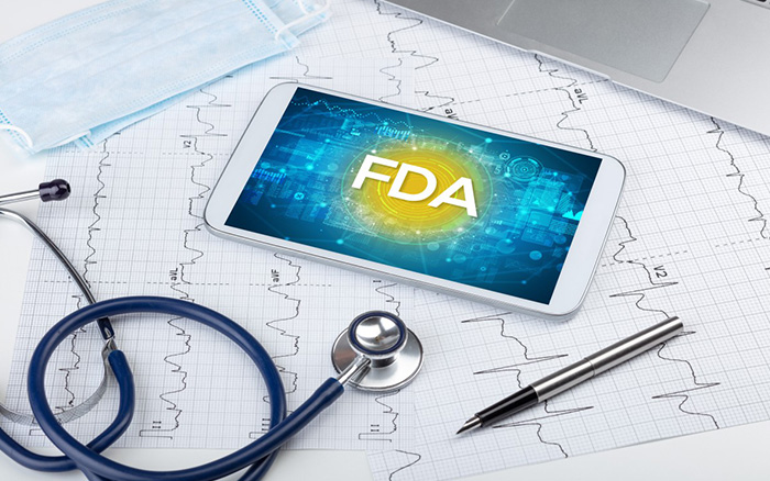 FDA shown on phone screen with mask, charts, pen and stethoscope